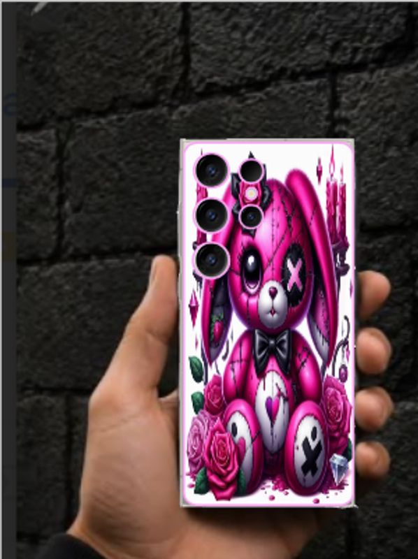 Hand holding phone with a pink stitched bunny case and roses.