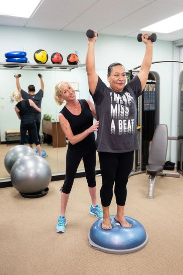 a woman instructor helping another woman