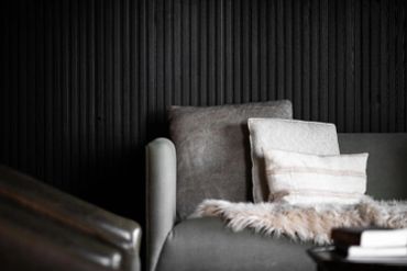 close up image of black acoustic slat wall panel