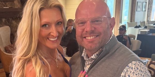 A happy couple posing together indoors.