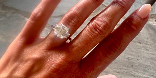 Hand with a sparkling diamond ring.