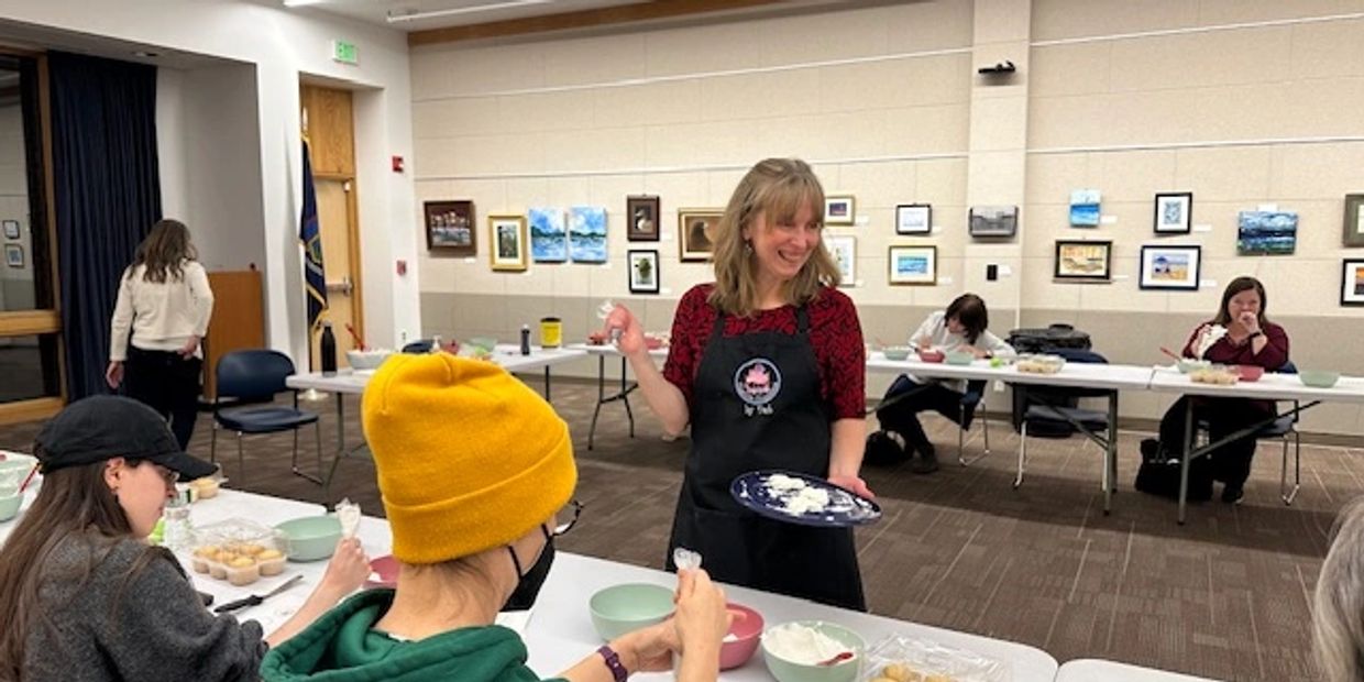 Instructor showing cupcake frosting techniques