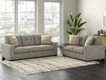 Modern living room with gray sofas and a soft cream rug.