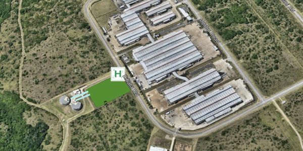 Aerial view of an industrial area surrounded by greenery.