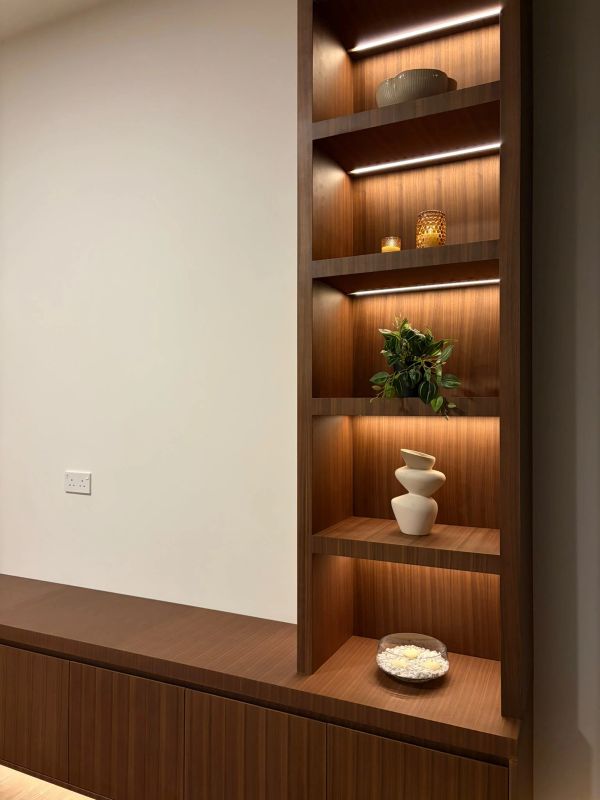 Wooden shelves with decorative items and soft lighting.