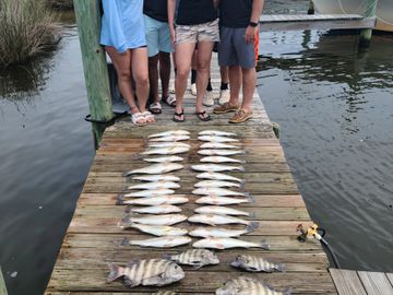 group of people on a charter with a mess of fish