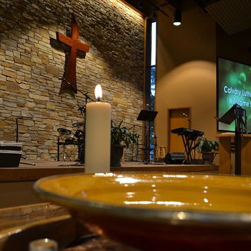 Inside Calvary Lutheran Church with a lit candle and worship setup.