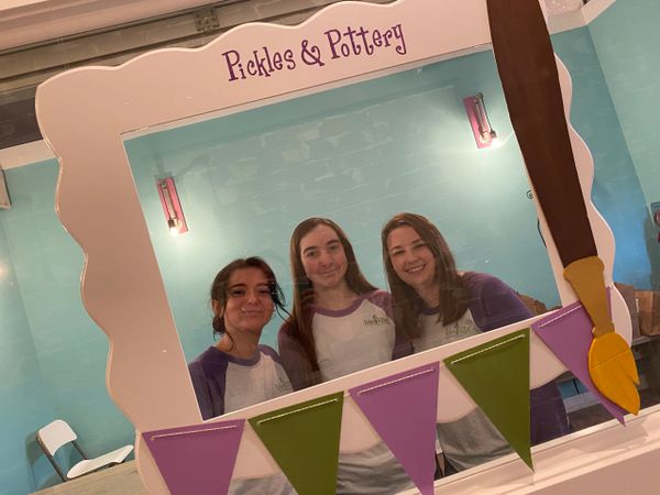 A frame design with three people behind it