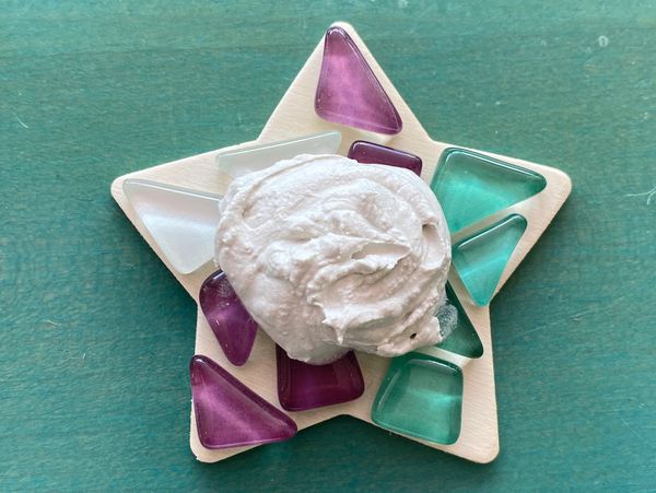 A star with three mosaic colors and a smudge of white