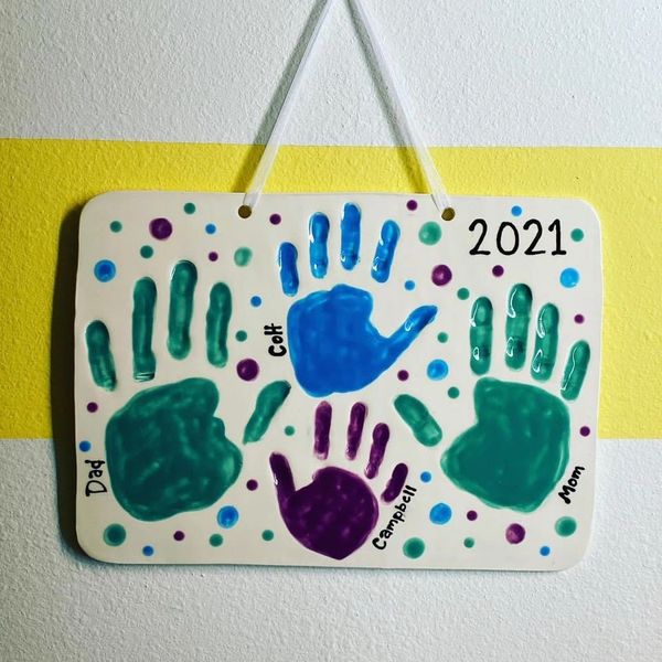Handprints of a family on a ceramic