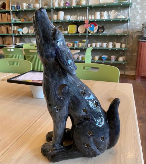 A ceramic dog howling