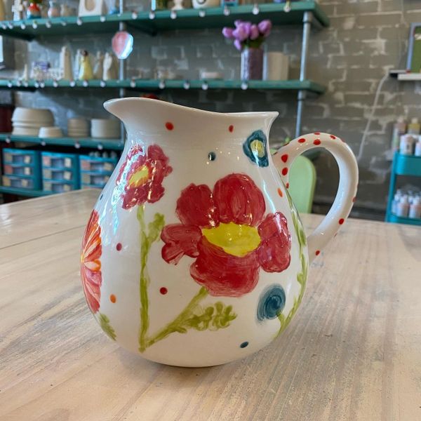 A ceramic jar with flower designs