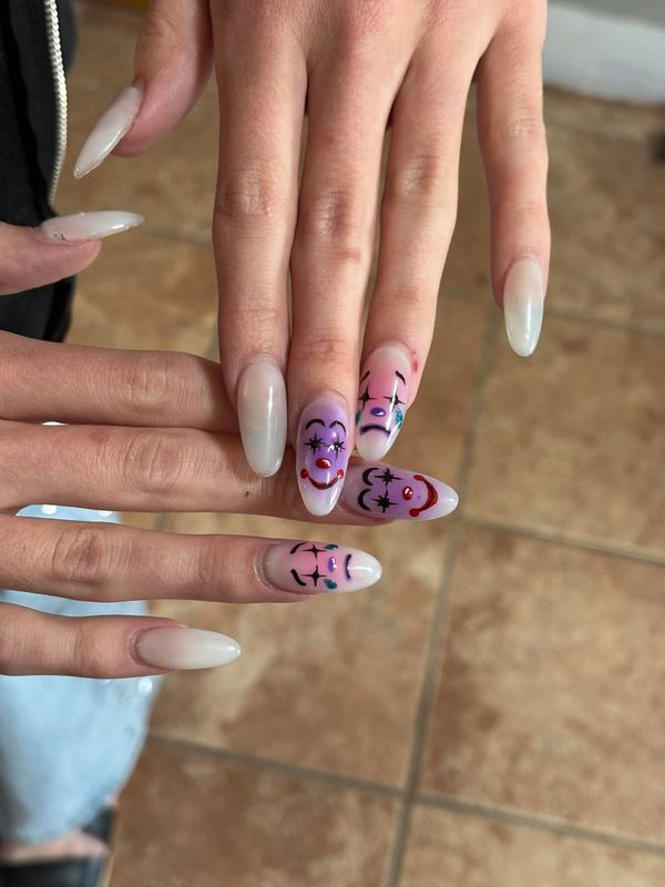 Long nails with clown faces painted on some fingers.