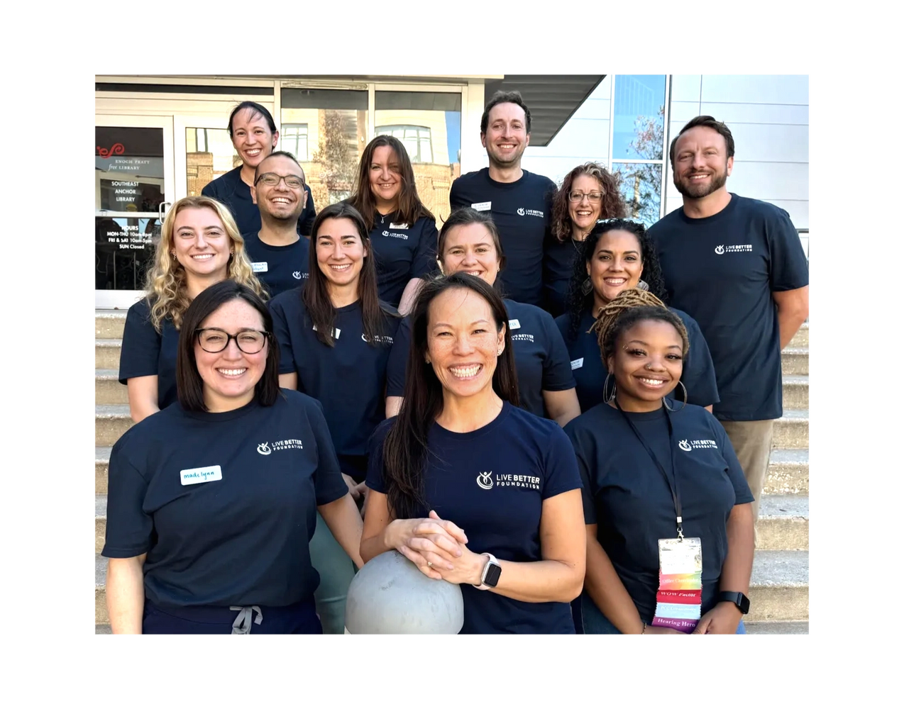 Group photo of smiling people wearing matching Live Better Foundation shirts.