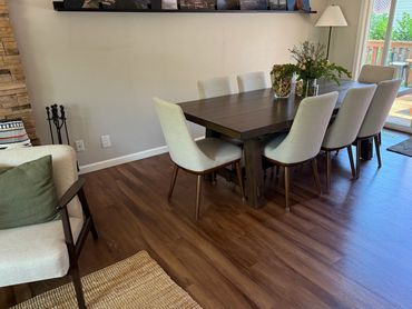 Modern dining room with wooden table and beige chairs.
