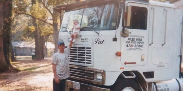 Taylor with her dad and his first mobile home toter in August 1999.