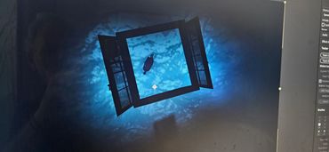 A silhouette of a person seen through an open window against a blue background.