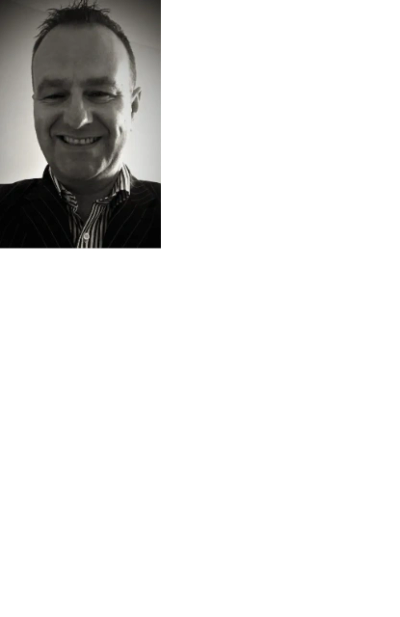 Smiling man in a striped suit and shirt, black and white photo.
