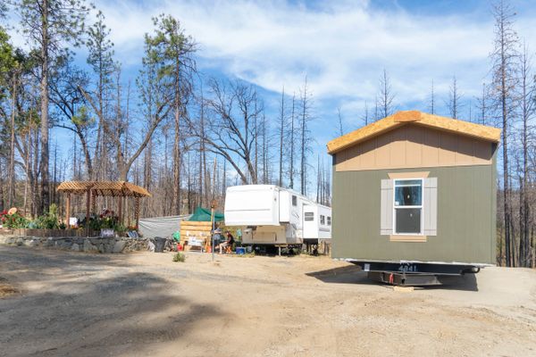 An outside view of an RV and a mobile home side by side
