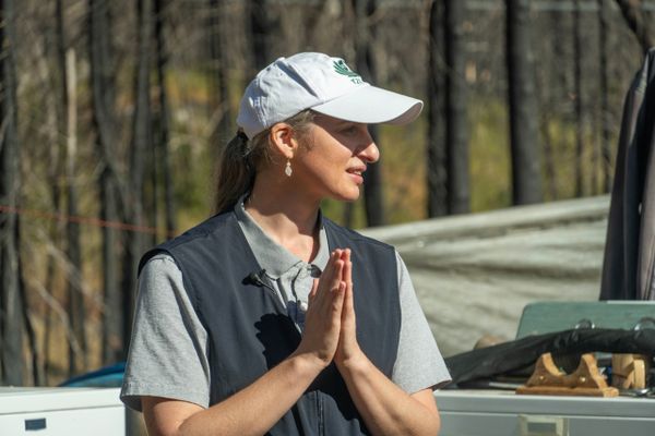 Bobby Ray Jones looks over her shoulder as she raises her hands in front of her heart in a prayer