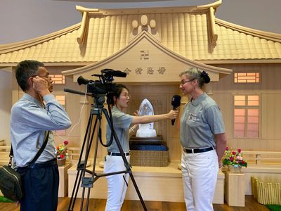 Bobbie Rae Jones stands with 2 other people as she gets interviewed by a woman holding a microphone