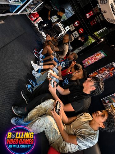 A group of people intensely playing video games together indoors.