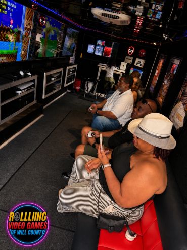 People enjoying retro video games in a cozy gaming room.
