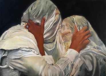 Two figures in white fabric embrace intimately against a dark background.