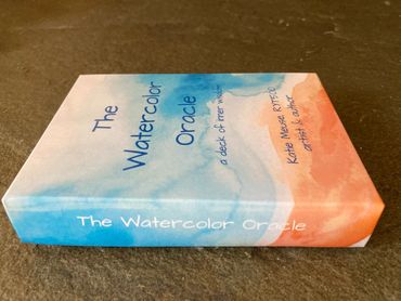 A colorful box of The Watercolor Oracle deck by Katie Meuse.