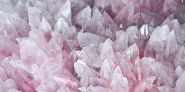 Cluster of pink quartz crystals with sharp, translucent points.