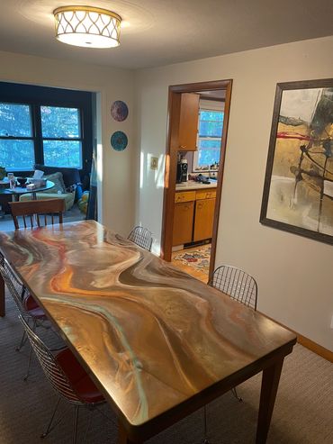 8' dining table using the colors from the painting on the wall.