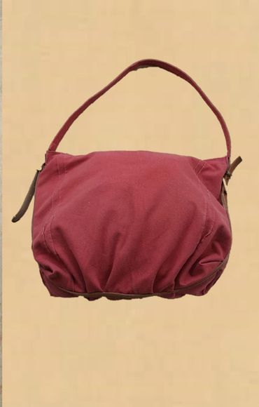 Trimmed with a leather belt to maintain its shape.