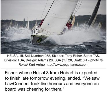 Sailboat Helsal III cutting through rough waters during a race with crew in red jackets.