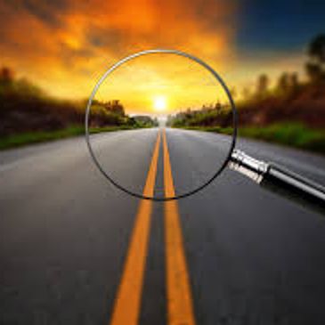 Magnified view of a road's double yellow lines at sunset.