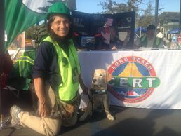 Marcia with puppy in training at a CERT booth