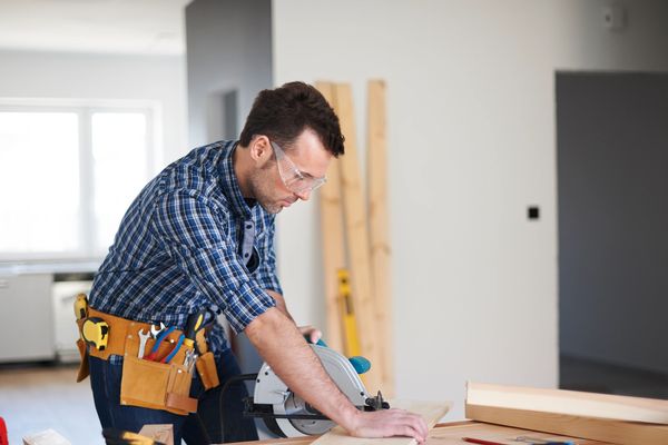 The central figure is a man, likely in his 30s or 40s, with dark hair.