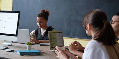 Teens in a classroom working on computers
