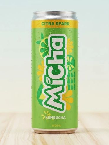 Green can of Mícha Citra Spark kombucha on a wooden surface.