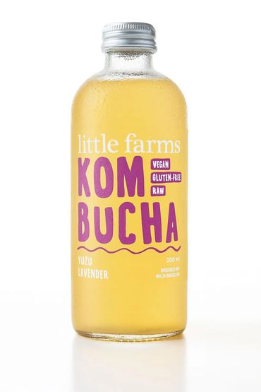A glass bottle of Little Farms Kombucha, Yuzu Lavender flavor, labeled vegan and gluten-free.