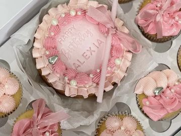 Pink-themed birthday cupcakes with "Happy Birthday Alexia" cake.