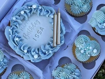 Blue-themed birthday cake and cupcakes for Issa.