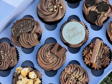 Assorted chocolate cupcakes with various toppings.