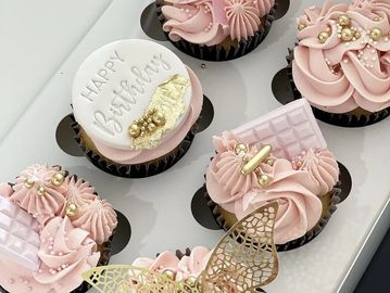 Decorative pink cupcakes with gold accents.