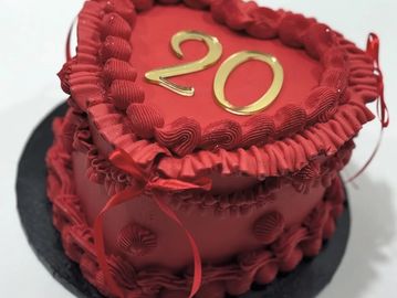 Heart-shaped red cake with the number 20 on top.