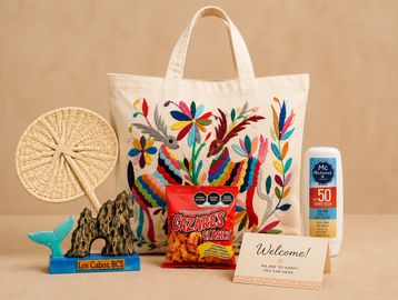 Colorful tote bag with snacks, sunscreen, and souvenirs on a beige background.