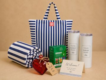 Welcome gift set with striped bag, blanket, tumblers, and thank you heart.