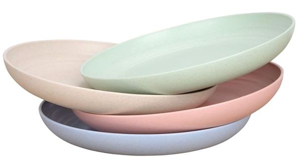 Stacked pastel-colored plates in light green, pink, beige, and blue.
