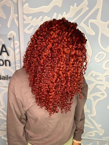Bright copper red on natural curly hair.
