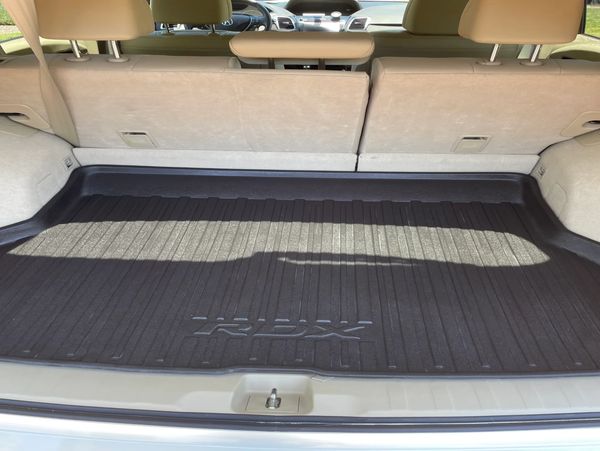 Empty Acura RDX trunk with protective mat.