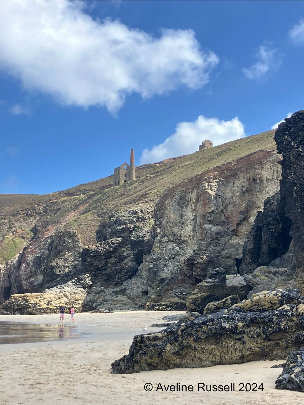 Mine engine house on cliffs above beach